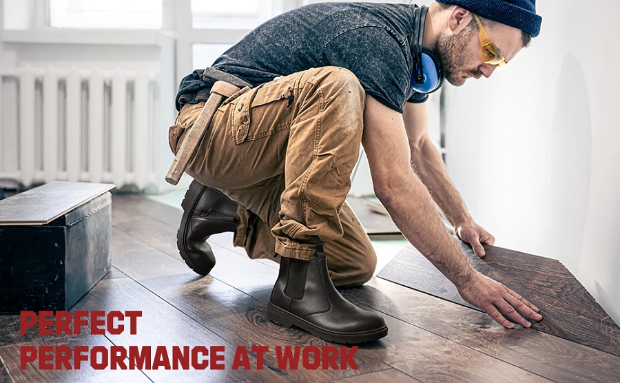 Worker wearing safety chelsea boots on construction job site demonstrating proper workplace footwear protection